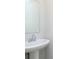 Stylish bathroom featuring a pedestal sink, mirror, and modern fixtures at 1257 Newton St, Avon, IN 46123