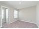 Inviting bedroom with soft carpet, a bright window, and a doorway to another room at 1257 Newton St, Avon, IN 46123
