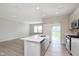 Well-lit kitchen featuring an island with a sink and stainless steel appliances at 1257 Newton St, Avon, IN 46123