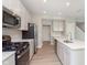 Modern kitchen boasting stainless appliances, a gas range, and a central island sink at 1257 Newton St, Avon, IN 46123