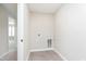 Functional laundry room with tiled floor, washer hookups, and ample space for laundry tasks at 1257 Newton St, Avon, IN 46123