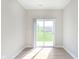 Bright living room with wood floor and sliding glass door opening to outdoor green space at 1257 Newton St, Avon, IN 46123