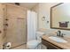 Bathroom featuring a tiled shower with glass door, neutral vanity, and toilet at 1280 Vicksburg S Dr, Greenwood, IN 46143
