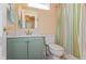 Bathroom featuring a mint green vanity, vertically striped shower curtain, and a toilet at 1280 Vicksburg S Dr, Greenwood, IN 46143