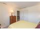 Bedroom featuring light yellow walls, woven dresser, and a view to the hallway at 1280 Vicksburg S Dr, Greenwood, IN 46143