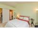 Bedroom featuring a queen bed, small bedside table, and open sliding door to ensuite at 1280 Vicksburg S Dr, Greenwood, IN 46143