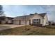 The home's exterior features an attached two-car garage, tidy lawn, and inviting entrance at 1280 Vicksburg S Dr, Greenwood, IN 46143