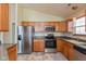A well-lit kitchen featuring stainless steel appliances, light wood cabinets, and neutral countertops at 1280 Vicksburg S Dr, Greenwood, IN 46143