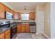 A bright kitchen with light wooden cabinets, stainless steel appliances, and a window above the sink at 1280 Vicksburg S Dr, Greenwood, IN 46143