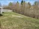 Large grassy backyard with a chain link fence and mature trees offering shade and privacy at 1282 Highpointe Blvd, Shelbyville, IN 46176