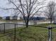 Serene backyard view of a pond, surrounded by lush greenery and neighboring homes at 1282 Highpointe Blvd, Shelbyville, IN 46176