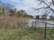 Scenic backyard featuring a peaceful pond with a chain link fence and gate at 1282 Highpointe Blvd, Shelbyville, IN 46176