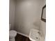 Half bathroom with wood floors, pedestal sink, and framed mirror at 1282 Highpointe Blvd, Shelbyville, IN 46176