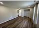 Bright bedroom with wood-look vinyl flooring, closet, and access to an ensuite bathroom at 1282 Highpointe Blvd, Shelbyville, IN 46176
