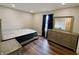 Bedroom showcases hardwood floors, large window with curtains, and dresser at 1282 Highpointe Blvd, Shelbyville, IN 46176