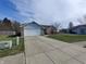 Inviting single-Gathering home showcasing a spacious driveway, attached garage, and a cozy front yard at 1282 Highpointe Blvd, Shelbyville, IN 46176