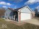 Charming one story home featuring a brick facade and two car garage at 1282 Highpointe Blvd, Shelbyville, IN 46176