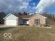 Traditional home with a two-car garage and a welcoming entrance at 1282 Highpointe Blvd, Shelbyville, IN 46176