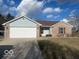 Inviting single story home with a two car garage and a well-manicured lawn at 1282 Highpointe Blvd, Shelbyville, IN 46176