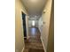 View of the long hallway leading into the house with new floors and neutral color walls at 1282 Highpointe Blvd, Shelbyville, IN 46176