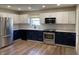 Modern kitchen featuring stainless steel appliances, two-tone cabinetry, and stylish backsplash at 1282 Highpointe Blvd, Shelbyville, IN 46176