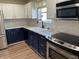 Beautifully updated kitchen with stainless steel appliances, a double sink, and modern cabinetry at 1282 Highpointe Blvd, Shelbyville, IN 46176