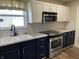 Updated kitchen featuring stainless steel appliances, sleek countertops, and ample cabinet space at 1282 Highpointe Blvd, Shelbyville, IN 46176