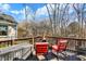 Open back deck with seating offering a peaceful view of the surrounding backyard and wooded area at 1307 Estuary Dr, Indianapolis, IN 46217