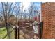 Back deck with outdoor furniture showcasing views of the fenced backyard and surrounding trees at 1307 Estuary Dr, Indianapolis, IN 46217