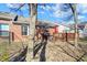 Exterior shot displaying the wooden deck area connected to the brick home within the fenced yard at 1307 Estuary Dr, Indianapolis, IN 46217