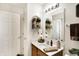 Bright bathroom features a white sink, large mirror, and ample lighting at 1307 Estuary Dr, Indianapolis, IN 46217