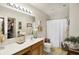 Well-lit bathroom featuring a vanity with storage, a large mirror, and a shower with a curtain at 1307 Estuary Dr, Indianapolis, IN 46217