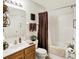 Well-lit bathroom features a shower, white sink, and warm brown accents at 1307 Estuary Dr, Indianapolis, IN 46217