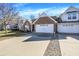 Exterior view showing a well-maintained house with a spacious driveway and attached two-car garage at 1307 Estuary Dr, Indianapolis, IN 46217