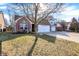 Charming home exterior with well-manicured lawn and a driveway leading to an attached garage at 1307 Estuary Dr, Indianapolis, IN 46217