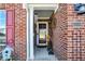 Cozy front porch adorned with brick accents, a decorative wreath, and a birdhouse for a charming touch at 1307 Estuary Dr, Indianapolis, IN 46217
