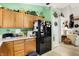 Contemporary kitchen showcasing wooden cabinetry, black refrigerator, and an open layout at 1307 Estuary Dr, Indianapolis, IN 46217