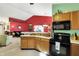 Open kitchen featuring wood cabinets, modern appliances, and seamless flow into the living area at 1307 Estuary Dr, Indianapolis, IN 46217