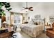 Spacious main bedroom with a ceiling fan, a desk area, and large windows for natural light at 1307 Estuary Dr, Indianapolis, IN 46217