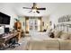 Sunlit main bedroom with a ceiling fan, a workstation, and a comfortable chair at 1307 Estuary Dr, Indianapolis, IN 46217