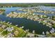 An aerial view of luxury homes on a lake with stunning waterfront access and lush landscaping at 13499 Marjac Way, Fishers, IN 46055