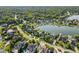 Stunning aerial view of lakeside homes with private docks surrounded by lush trees and manicured lawns at 13499 Marjac Way, Fishers, IN 46055