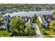 Aerial view showcasing a lakefront home with lush landscaping and neighborhood at 13499 Marjac Way, Fishers, IN 46055