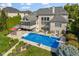 Aerial view of the backyard pool and patio of a brick home with a screen porch at 13499 Marjac Way, Fishers, IN 46055