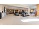 Open basement area features a large entertainment space, bar area, and workout equipment at 13499 Marjac Way, Fishers, IN 46055
