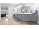 Bright bathroom featuring a double vanity, updated fixtures, and an open doorway leading into the primary bedroom at 13499 Marjac Way, Fishers, IN 46055