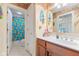 Bright bathroom with wood cabinet, tropical shower curtain, and beach themed decorations at 13499 Marjac Way, Fishers, IN 46055