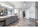 Elegant bathroom featuring a double vanity, large mirror, and a separate tub and shower at 13499 Marjac Way, Fishers, IN 46055