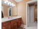 Bathroom with single sink vanity, bright lighting and view to the toilet/shower room at 13499 Marjac Way, Fishers, IN 46055