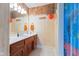 Bathroom with vanity, mirror, beach-themed decor and accent lighting at 13499 Marjac Way, Fishers, IN 46055